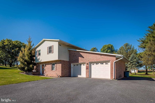 view of side of home with a yard and a garage