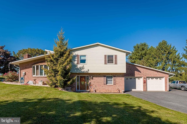 view of front of property with a front yard and a garage