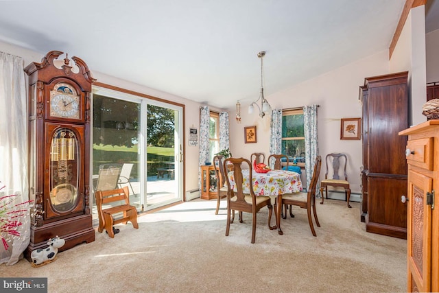 carpeted dining room featuring lofted ceiling and a baseboard heating unit