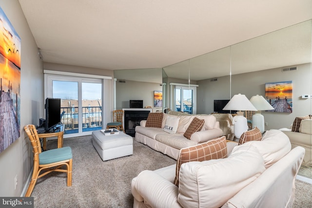 living room featuring a wealth of natural light, carpet floors, and lofted ceiling