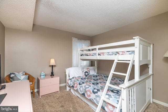 carpeted bedroom with a textured ceiling