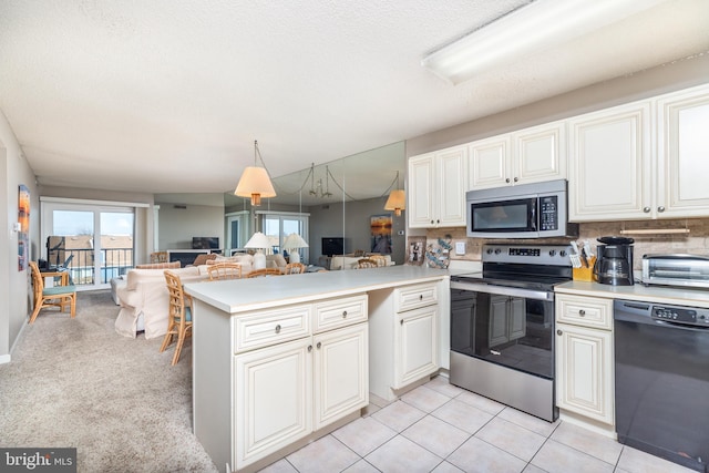 kitchen featuring hanging light fixtures, tasteful backsplash, kitchen peninsula, light tile patterned flooring, and appliances with stainless steel finishes