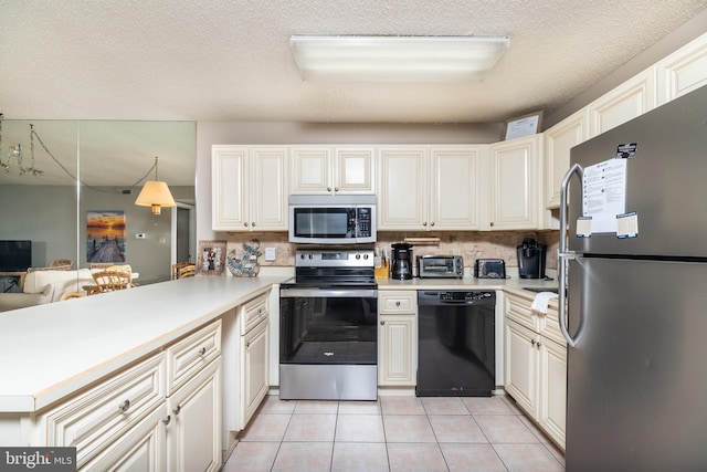 kitchen with kitchen peninsula, appliances with stainless steel finishes, a textured ceiling, light tile patterned floors, and hanging light fixtures