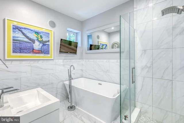 bathroom with vanity, plus walk in shower, and tile walls