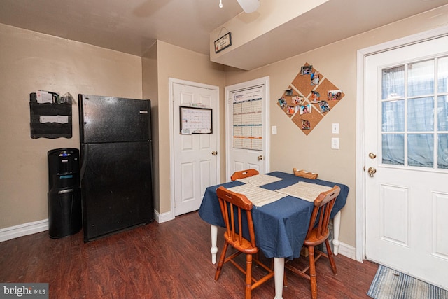 dining space with ceiling fan and dark hardwood / wood-style floors