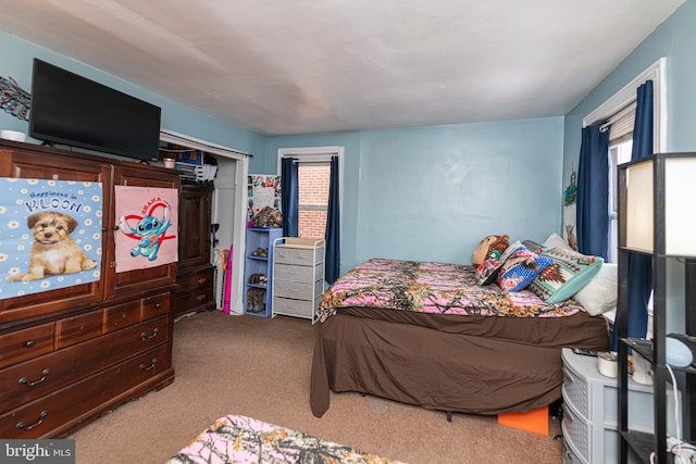 bedroom featuring light colored carpet