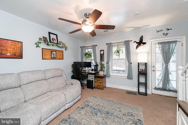 living room with light colored carpet, plenty of natural light, and ceiling fan