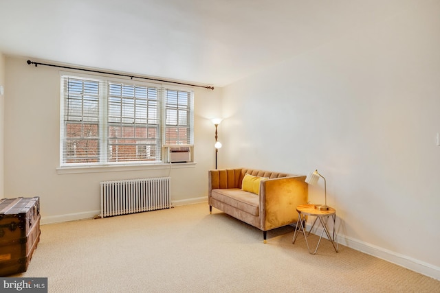 sitting room with radiator heating unit, light colored carpet, and cooling unit