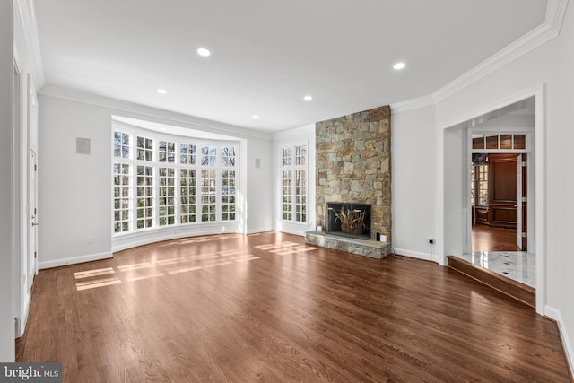 unfurnished living room featuring crown molding, dark hardwood / wood-style floors, and a stone fireplace