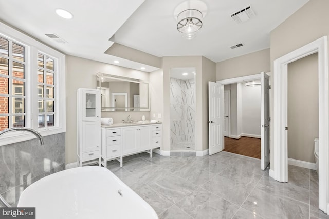 full bathroom featuring toilet, separate shower and tub, and vanity