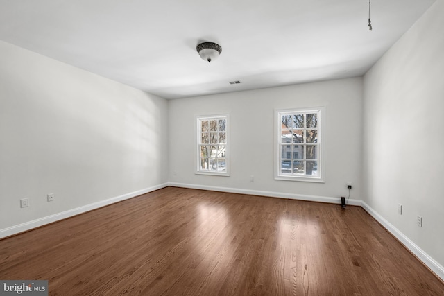 spare room with dark wood-type flooring