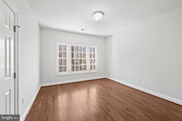 spare room with hardwood / wood-style flooring