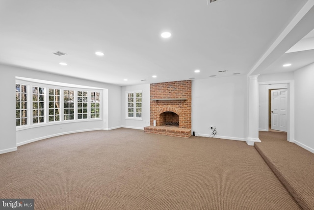 unfurnished living room with a brick fireplace and carpet flooring