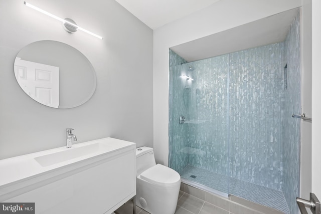 bathroom with toilet, a tile shower, tile patterned floors, and vanity