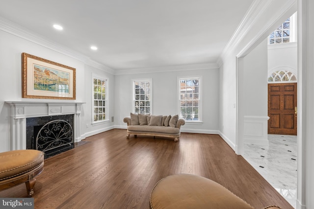 living room with ornamental molding, a fireplace, and hardwood / wood-style floors