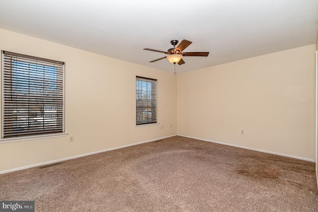 carpeted empty room featuring ceiling fan