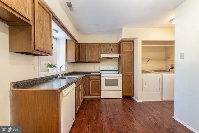 kitchen with sink, white appliances, washing machine and dryer, and dark hardwood / wood-style floors