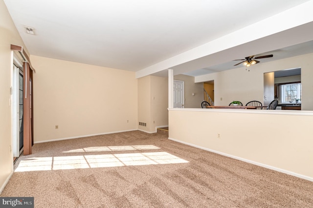 unfurnished living room featuring light colored carpet