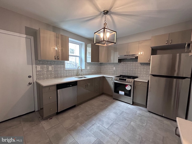 kitchen with gray cabinetry, sink, hanging light fixtures, and appliances with stainless steel finishes