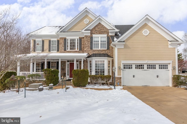 view of front of house with covered porch and a garage