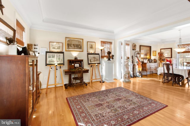 interior space with ornate columns, crown molding, and hardwood / wood-style flooring