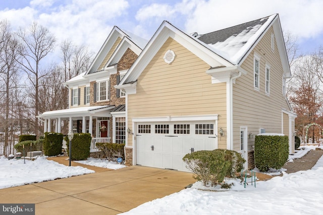 view of front of house with a porch and a garage