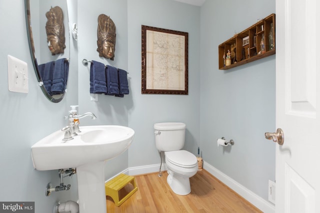 bathroom featuring hardwood / wood-style floors and toilet