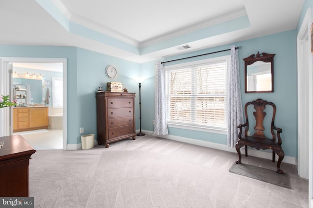 sitting room featuring ornamental molding, light carpet, and a tray ceiling