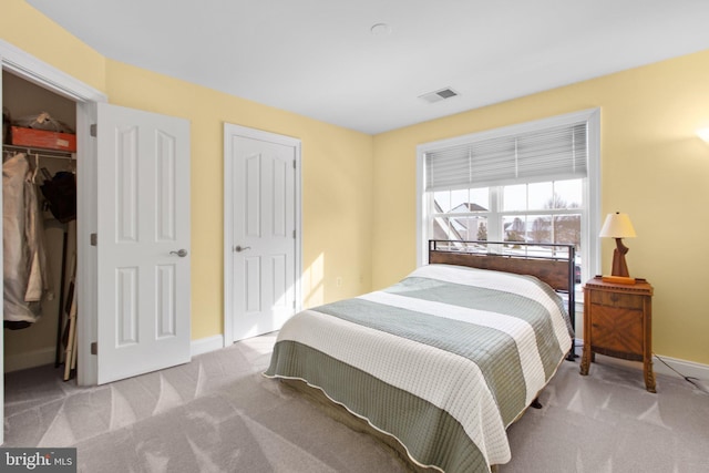 carpeted bedroom featuring a spacious closet and a closet