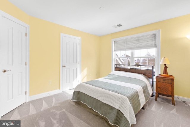 bedroom with light colored carpet