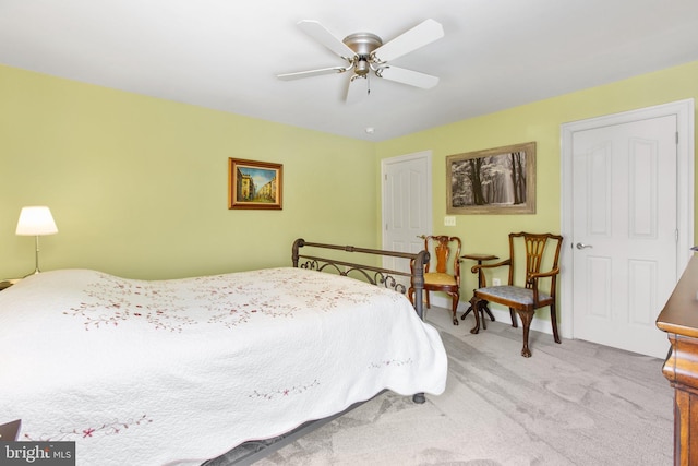 bedroom with ceiling fan and light carpet