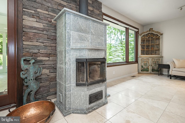 living room featuring a fireplace and light tile patterned floors