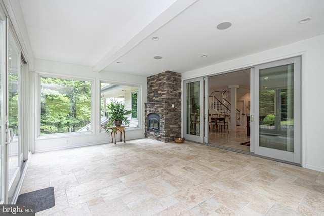 unfurnished sunroom featuring beam ceiling