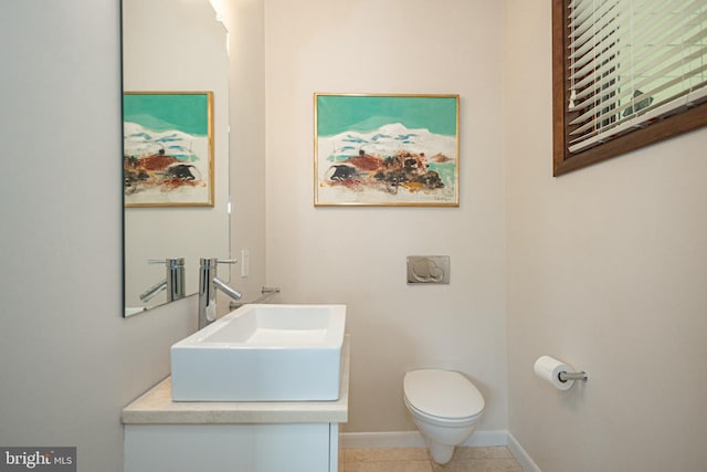 bathroom featuring tile patterned flooring, vanity, and toilet