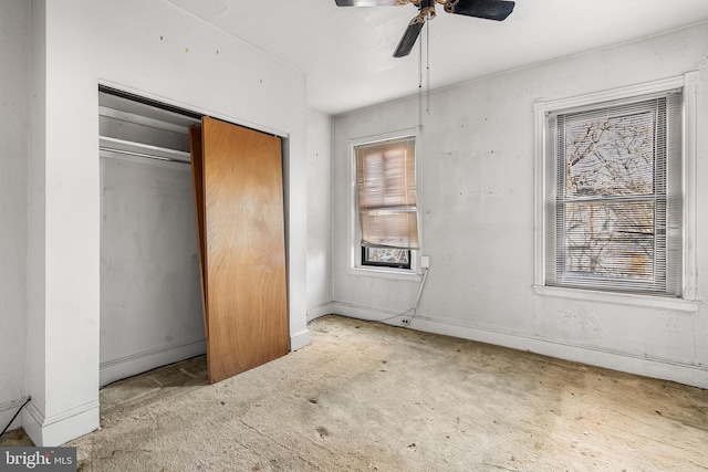 unfurnished bedroom with light carpet, ceiling fan, and a closet