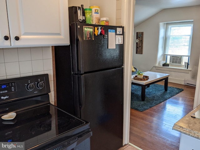 kitchen featuring light wood-type flooring, backsplash, black appliances, white cabinets, and lofted ceiling