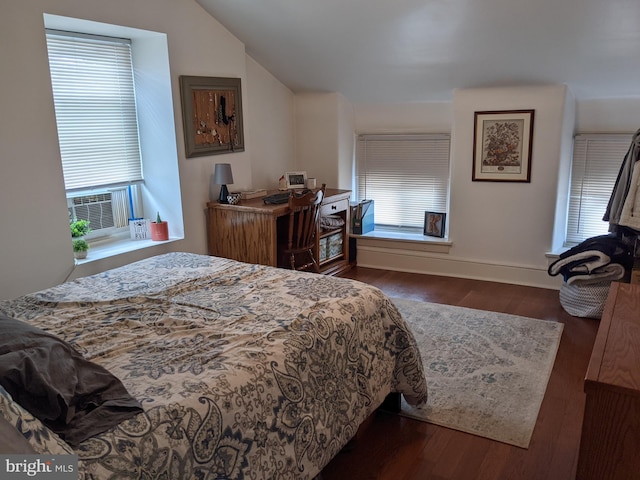 bedroom featuring dark hardwood / wood-style flooring and vaulted ceiling