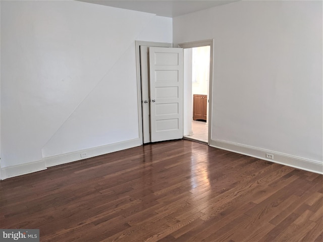 unfurnished room with dark hardwood / wood-style floors