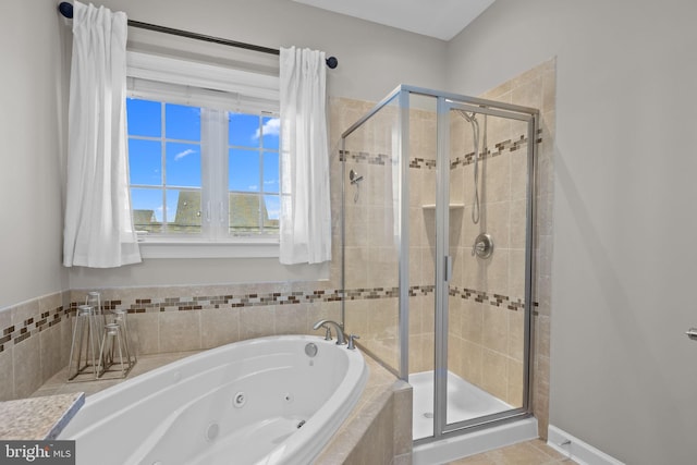 bathroom with tile patterned floors and plus walk in shower