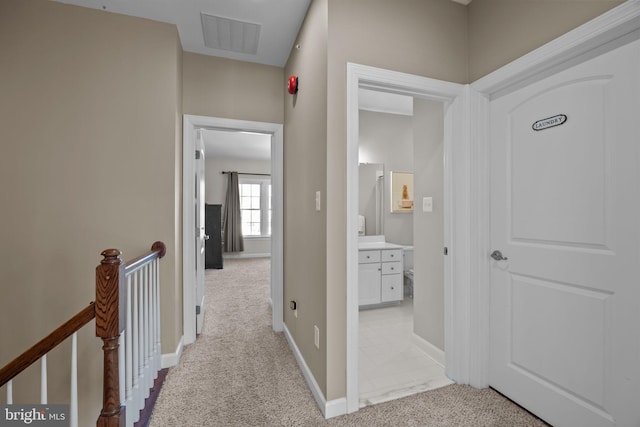 hallway with light colored carpet