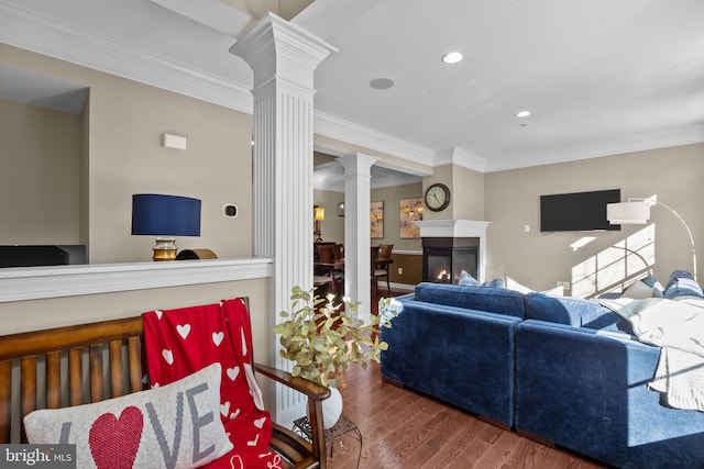 living room featuring ornamental molding, dark hardwood / wood-style floors, and ornate columns