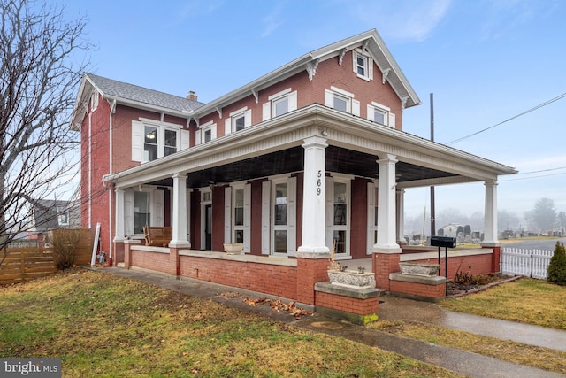 view of front of home featuring a front yard and covered porch