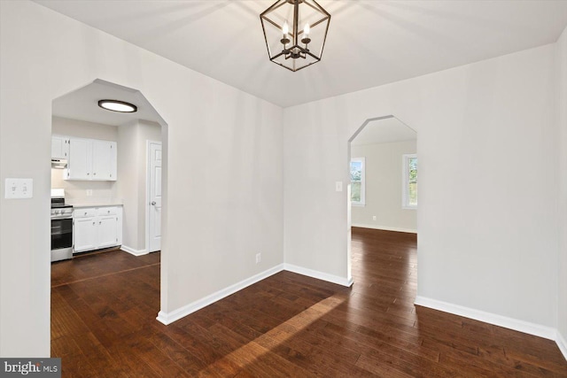 interior space with dark hardwood / wood-style flooring and an inviting chandelier