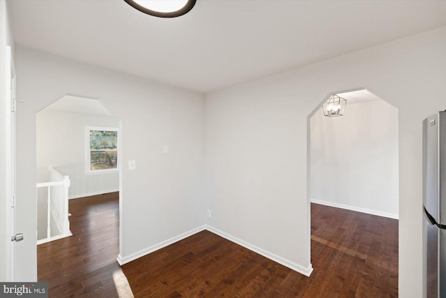 unfurnished room featuring dark wood-type flooring