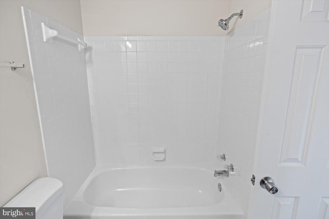 bathroom with bathtub / shower combination and toilet