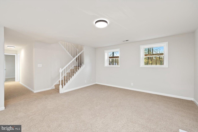 basement featuring light colored carpet