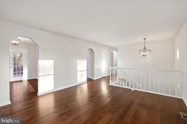 spare room with dark wood-type flooring