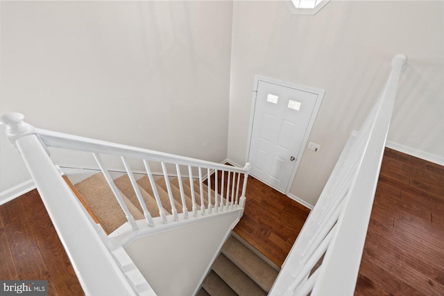 staircase with hardwood / wood-style floors