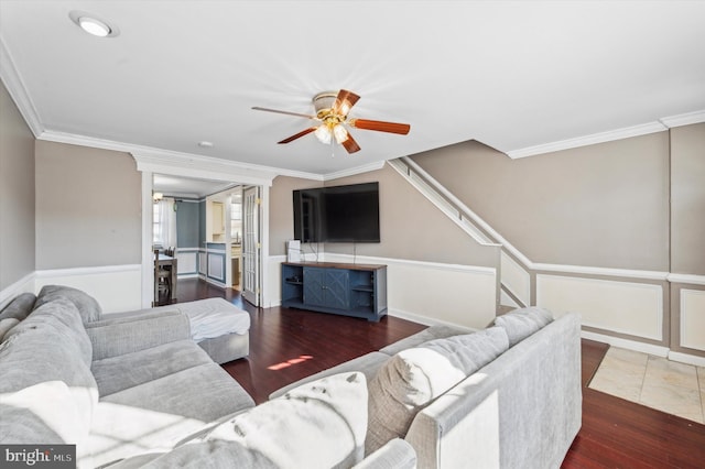 living room with dark wood-type flooring and crown molding