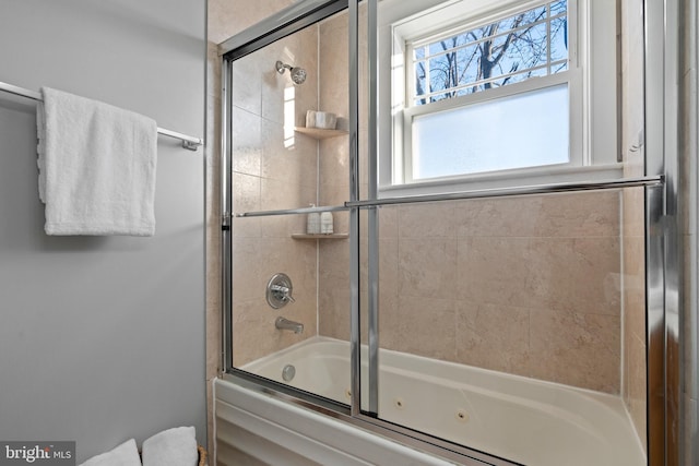 bathroom with combined bath / shower with glass door